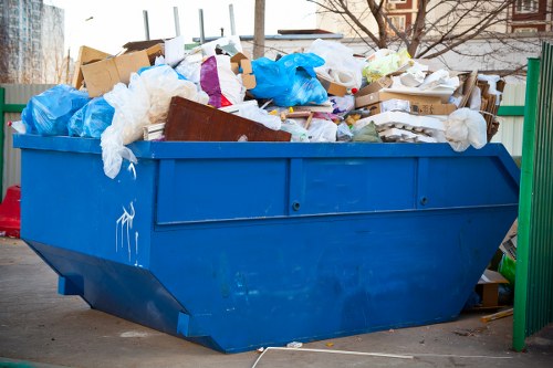 Team loading a half-lorry with household waste in Edmonton